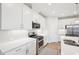 The kitchen has white cabinets, stainless steel appliances, a gas range, and subway tile backsplash, creating a clean and modern look at 1003 Canary Pepper Dr, Durham, NC 27713