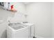 Functional laundry room boasts modern washer, dryer, and storage shelving at 1003 Canary Pepper Dr, Durham, NC 27713