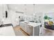 An open-concept kitchen, dining and living space offers modern living with an island, and comfortable seating area at 1003 Canary Pepper Dr, Durham, NC 27713