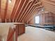 Spacious unfinished attic space features a window and wooden beams at 1008 Brittley Way, Apex, NC 27502