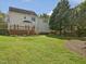 Exterior view of the back of the home featuring a wooden deck and a large yard at 1008 Brittley Way, Apex, NC 27502