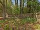 Landscaped backyard with mulch and green plants, with a wooden fence at 1008 Brittley Way, Apex, NC 27502