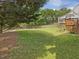Large backyard with a wooden deck and partial fencing at 1008 Brittley Way, Apex, NC 27502