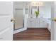 Bathroom featuring a double vanity with white cabinets and a tiled shower with a glass door at 1008 Brittley Way, Apex, NC 27502
