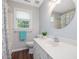 Bathroom with white vanity and sink, round mirror, and tub/shower with curtain at 1008 Brittley Way, Apex, NC 27502