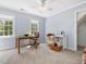 Bright bedroom features neutral carpet, two windows, a ceiling fan, and a sewing station at 1008 Brittley Way, Apex, NC 27502