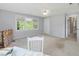 Bright bedroom features neutral carpet, a large window, white painted walls, and two points of entry at 1008 Brittley Way, Apex, NC 27502