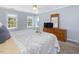 Bedroom with natural light, a ceiling fan, dresser with a mirror, and carpet flooring at 1008 Brittley Way, Apex, NC 27502