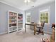 Bright bedroom features neutral carpet, built-in bookshelves, and large windows with views to outside at 1008 Brittley Way, Apex, NC 27502