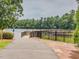 A scenic community dock and walking path provide access to a serene lake, offering a peaceful retreat and outdoor recreation at 1008 Brittley Way, Apex, NC 27502