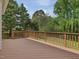 Large deck with wood railing, perfect for outdoor entertaining and relaxation with natural light at 1008 Brittley Way, Apex, NC 27502