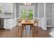 Lovely dining space with wainscoting and French doors leading to a deck and updated kitchen at 1008 Brittley Way, Apex, NC 27502