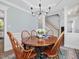 Formal dining room featuring wainscoting, crown molding, elegant chandelier, and stylish decor at 1008 Brittley Way, Apex, NC 27502