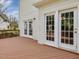Exterior view of the home showcasing French doors and a spacious backyard deck at 1008 Brittley Way, Apex, NC 27502