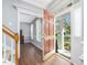 Inviting foyer with an open doorway to the porch and an adjacent living room with hardwood floors at 1008 Brittley Way, Apex, NC 27502