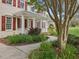 Inviting front porch with classic columns, red shutters, and landscaped walkway leading to the entrance at 1008 Brittley Way, Apex, NC 27502
