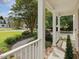 View from the porch with white railings overlooking the front yard and a sidewalk leading to the street at 1008 Brittley Way, Apex, NC 27502