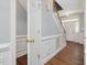 Welcoming foyer featuring hardwood floors, wainscoting, and a staircase leading to the upper level at 1008 Brittley Way, Apex, NC 27502