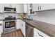 Kitchen featuring stainless steel appliances and beautiful stone countertops at 1008 Brittley Way, Apex, NC 27502