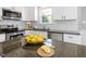 Close-up of kitchen with stainless steel appliances and stone countertops at 1008 Brittley Way, Apex, NC 27502