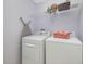 Well-lit laundry room featuring a washer, dryer, and overhead storage at 1008 Brittley Way, Apex, NC 27502