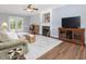 Cozy living room with fireplace, ceiling fan and french doors leading to a deck at 1008 Brittley Way, Apex, NC 27502