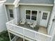 Cozy deck with white wooden furniture, railing, and a door leading inside, perfect for outdoor relaxation at 102 Choptank Ct # B5, Cary, NC 27513