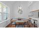 Bright dining area with a round table, modern lighting, and a large window at 102 Choptank Ct # B5, Cary, NC 27513