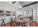 Open-concept dining room boasts wood floors, modern lighting, and seating for four at 102 Choptank Ct # B5, Cary, NC 27513