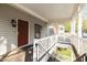 Inviting covered entrance with white lattice railing and adjacent doors leading to individual units at 102 Choptank Ct # B5, Cary, NC 27513