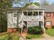 Charming two-story condo with a covered porch, brick foundation, and landscaped front yard at 102 Choptank Ct # B5, Cary, NC 27513