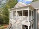 This beautiful home has a balcony with intricate latticework, fresh paint, and is surrounded by trees at 102 Choptank Ct # B5, Cary, NC 27513