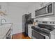 Well-equipped kitchen featuring modern appliances, granite countertops, and white cabinetry at 102 Choptank Ct # B5, Cary, NC 27513