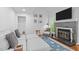 Comfortable living room with fireplace, television, stylish furnishings, and hardwood flooring at 102 Choptank Ct # B5, Cary, NC 27513