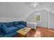Bright living space with plush sofa, bed, wood floors, and natural light from a window at 102 Choptank Ct # B5, Cary, NC 27513
