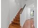 Wood staircase featuring modern design elements, including a dark wood handrail at 102 Choptank Ct # B5, Cary, NC 27513