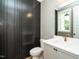 Modern bathroom with dark shiplap wall accent, white cabinets, and gold fixtures at 1029 Azalea Garden Cir, Raleigh, NC 27603