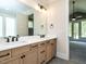 Bathroom features a double sink vanity with modern fixtures and an open doorway to a carpeted bedroom at 1029 Azalea Garden Cir, Raleigh, NC 27603
