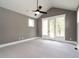 Spacious bedroom boasts neutral carpet, a ceiling fan, and glass doors leading to the outdoors at 1029 Azalea Garden Cir, Raleigh, NC 27603