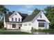Charming two-story home featuring white siding, a dark roof, manicured landscaping, and an attached two-car garage at 1029 Azalea Garden Cir, Raleigh, NC 27603