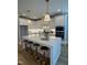 Modern kitchen with white cabinetry, quartz countertops, a large island, and sleek stainless steel appliances at 1029 Azalea Garden Cir, Raleigh, NC 27603