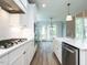 Open kitchen featuring white cabinetry, stainless appliances, gas range, and large island at 1029 Azalea Garden Cir, Raleigh, NC 27603