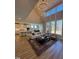 Open-concept living room boasts tall windows, a stylish chandelier, and seamless flow to the dining area and kitchen at 1029 Azalea Garden Cir, Raleigh, NC 27603