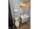 Charming powder room features a modern vanity with white countertop and gold fixtures, plus a decorative mirror at 1029 Azalea Garden Cir, Raleigh, NC 27603