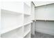 Well-organized walk-in closet featuring ample shelving and hanging rods for optimal storage solutions at 1029 Azalea Garden Cir, Raleigh, NC 27603