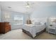 Bedroom with vaulted ceilings, ceiling fan, and neutral carpet at 1039 S Philwood Ct, Fuquay Varina, NC 27526
