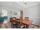 Formal dining room featuring hardwood table, decorative rug, and an adjacent doorway at 1039 S Philwood Ct, Fuquay Varina, NC 27526
