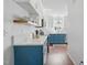 Bright kitchen with blue cabinets, white countertops, stainless steel appliances, and hardwood floors at 1039 S Philwood Ct, Fuquay Varina, NC 27526