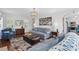 Comfortable living room with a plush sofa, ottoman, and hardwood floors at 1039 S Philwood Ct, Fuquay Varina, NC 27526