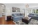 Cozy living room featuring comfortable seating, decorative rug, and ample natural light at 1039 S Philwood Ct, Fuquay Varina, NC 27526